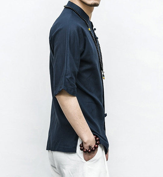 Person wearing a dark blue Men’s Linen Cotton Chinese Mandarin Collar Shirtwith a white background