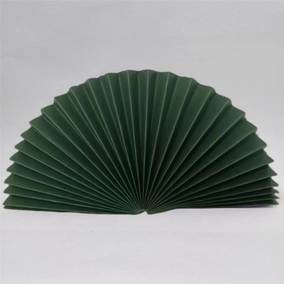 A dark green pleated accordion-style fan , shown open against a plain light gray background.