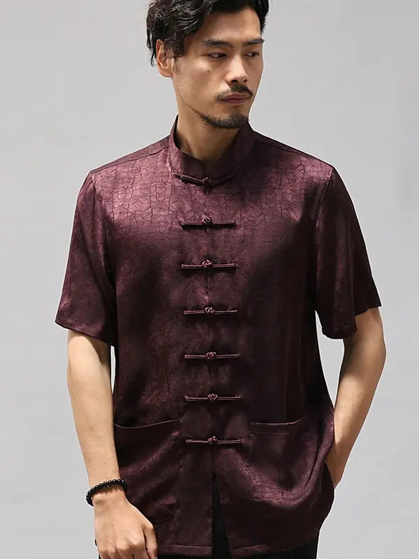 Man wearing a dark purple traditional Men's Luxury Mulberry Silk Jacquard Short Sleeve Tang Shirt outfit with short sleeves on a gray background