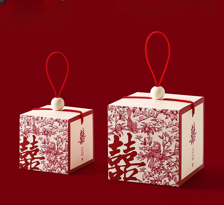 Chinese wedding favor boxes with red double happiness symbol, flowers and pair of birds represent and chinese blessing on the side