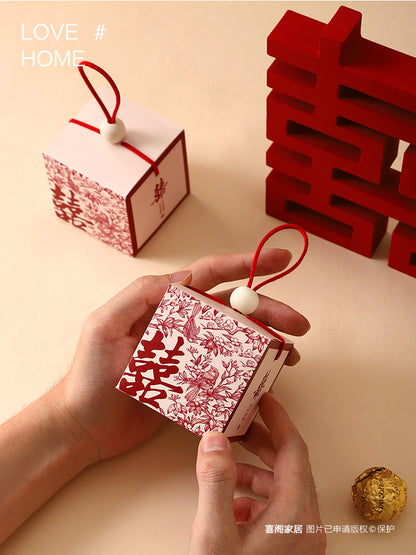 Chinese wedding favor boxes with red double happiness symbol, flowers and pair of birds represent good marriage