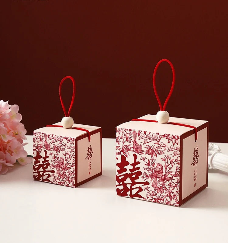 Chinese wedding favor boxes with red double happiness symbol, flowers and pair of birds 