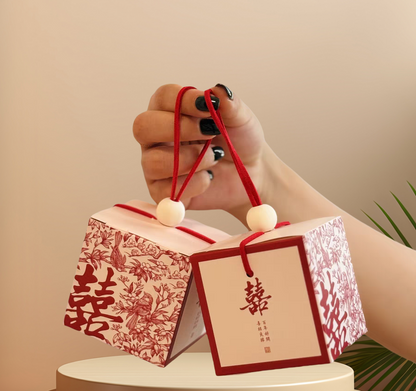 Chinese wedding favor boxes with red double happiness symbol, flowers and pair of birds represent good marriage