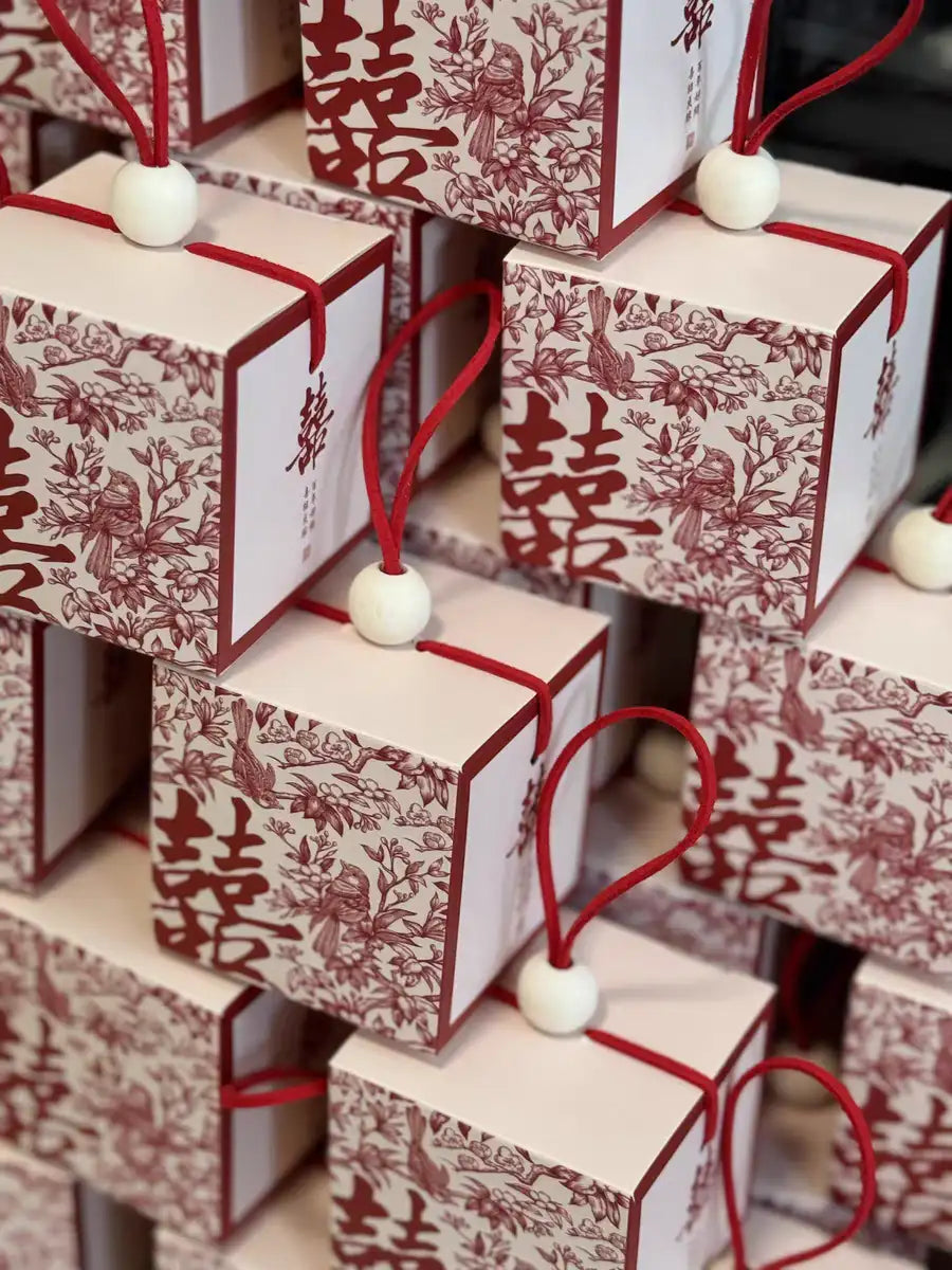 Chinese wedding favor boxes with red double happiness symbol, flowers and pair of birds 