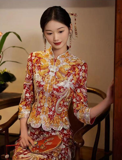 a chinese girl in red and gold traditional chinese wedding dragon pheonix qun kwa outfit