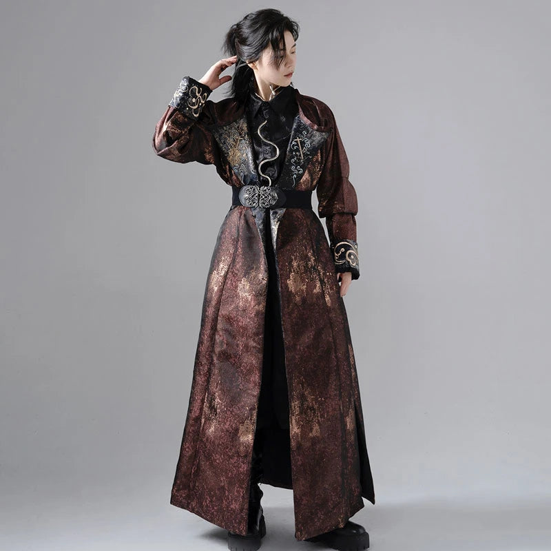 A man wearing a traditional Chinese Hanfu robe with reversible designs, featuring metallic splashes and embroidery on cuffs and lapels.