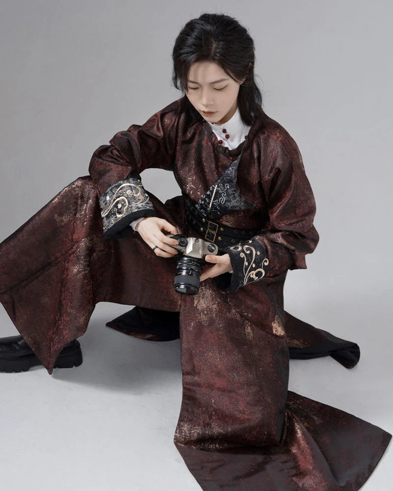a man in traditional Chinese Reversible Hanfu Robe coat holding a camera on a gray background