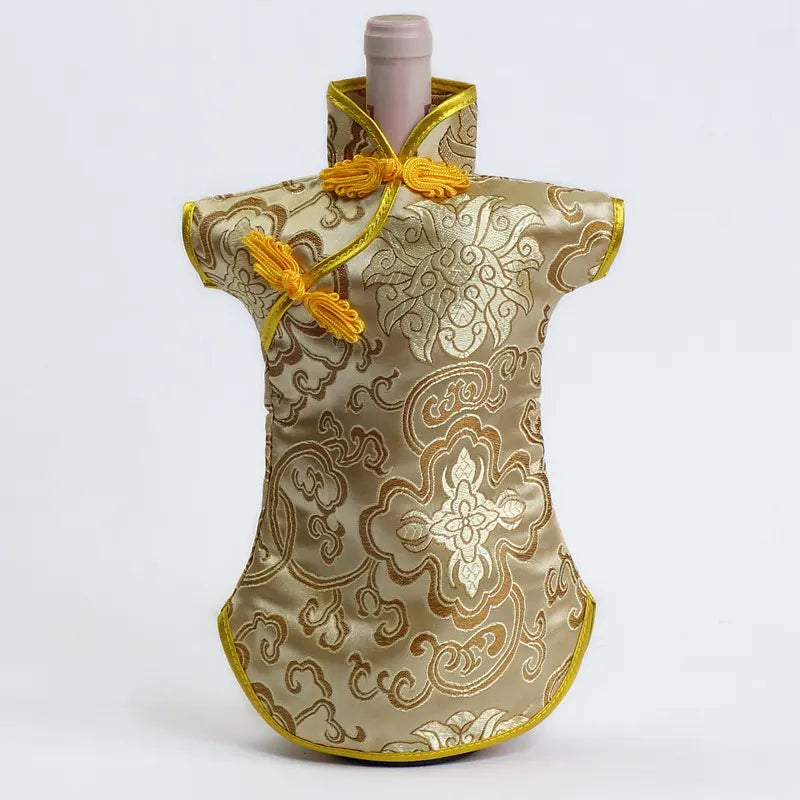 Decorative Traditional Chinese Cheongsam Dress Brocade Wine Bottle Cover  with intricate gold patterns on a white background