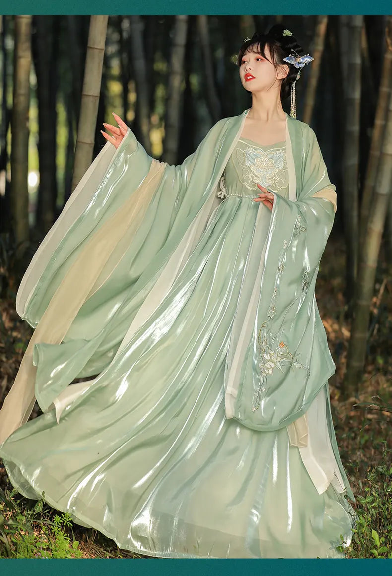 A chinese woman  wearing a traditional light green Chinese Tang Dynasty Ruqun Set Hanfu Dress  with a flowing cape in a forest setting