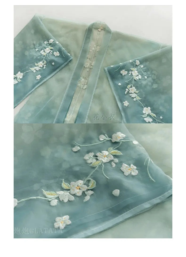 green  fabric with floral embroidery on a white background