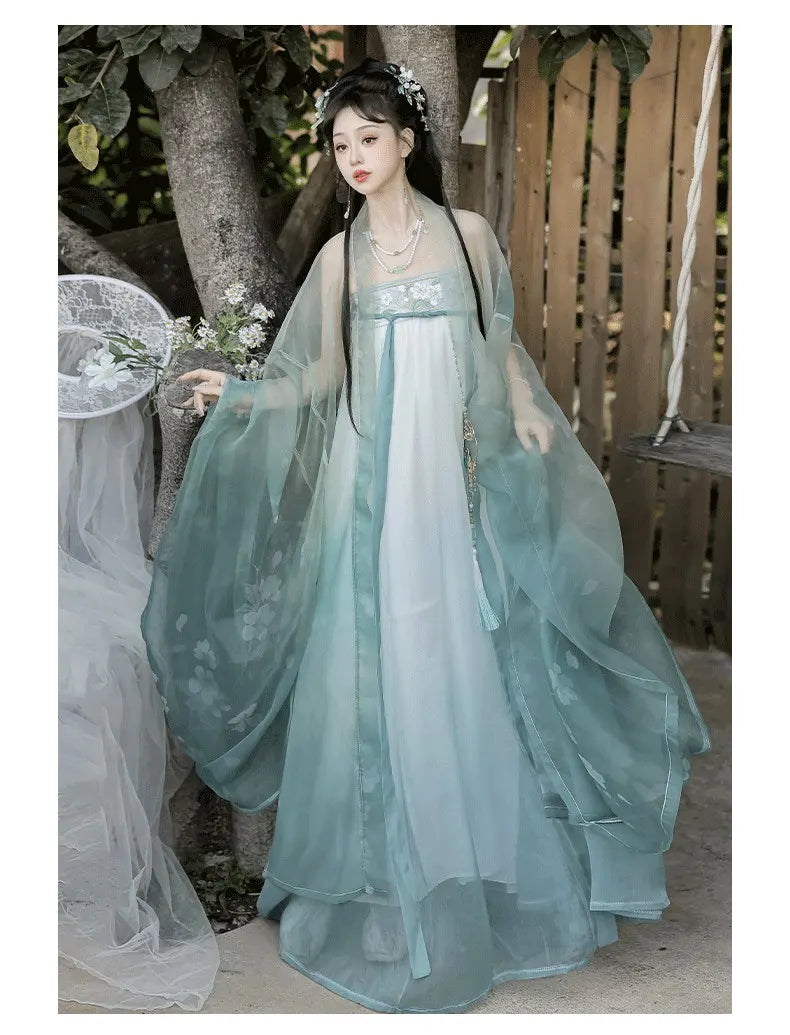 Woman in a green Floral Traditional Chinese Tang Dynasty Hanfu Dress set standing outdoors.