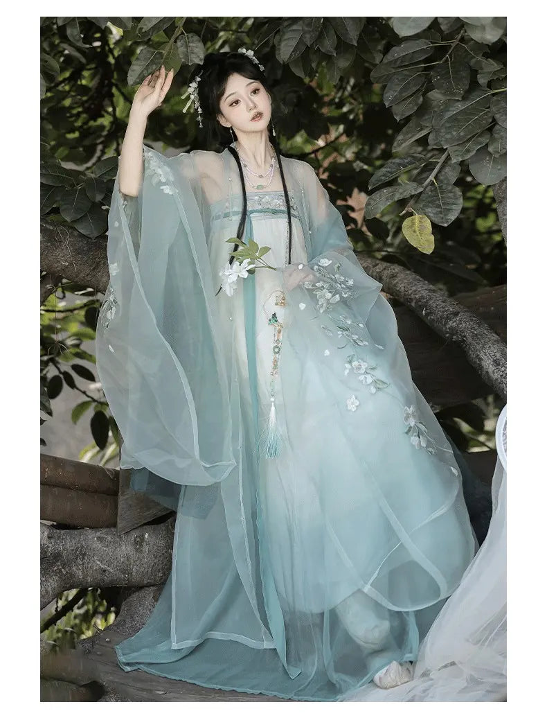 Person green Floral Traditional Chinese Tang Dynasty Hanfu Dress  garment with floral details standing among green foliage.
