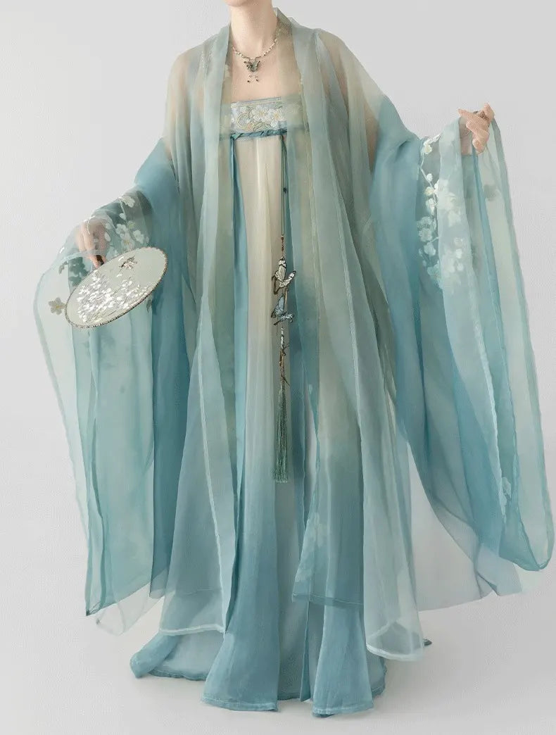 Traditional Chinese garment with flowing sleeves on a plain background