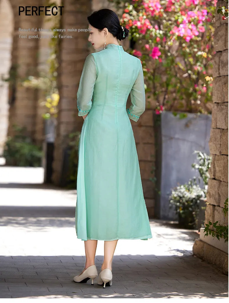 Woman in a light green Modern A-Line Tencel Jacquard Loose Cheongsam Qipao Dress  standing outdoors with flowers in the background