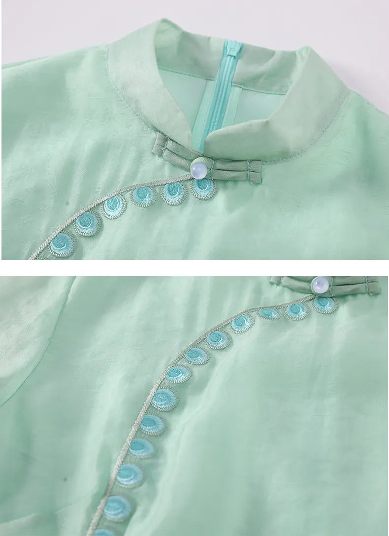 Light green garment with decorative buttons on a white background