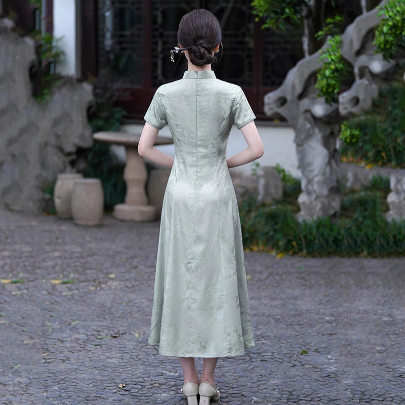 Woman in a light green Modern Ao Dai Style Floral Jacquard A-Line Qipao dress standing in a garden setting