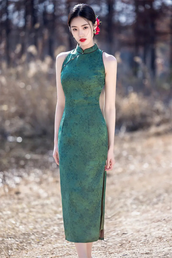 Woman in a green Modern Chinese Mandarin Dress Sleeveless Qipao  standing in a natural setting with blurred background