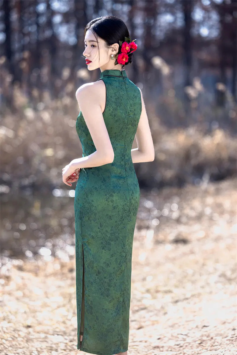 Woman in a green Modern Chinese Mandarin Dress Sleeveless Qipao  standing in a natural setting with trees and grass.