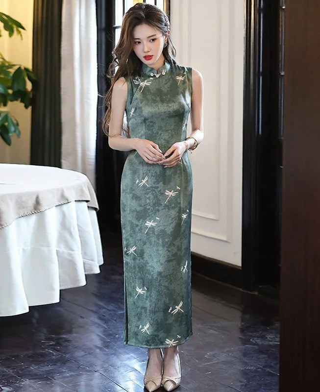 Woman wearing a green Modern Minimalist  Sleeveless Qipao With Dragonfly Print dress with white patterns in an indoor setting