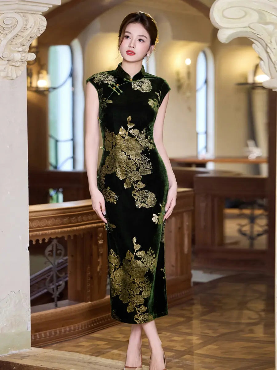 A woman models a sleeveless black velvet cheongsam dress with gold floral embroidery, standing in a warm, classic indoor hallway with wooden columns and arches.