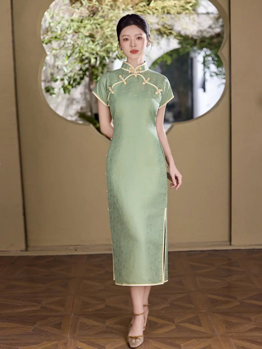 Woman wearing a  green traditional  Song Brocade Full-Opening  Chinese cheongsam Qipao Dress with floral patterns in an elegant setting.
