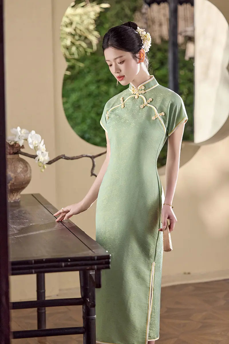 Woman in a light  green traditional  Song Brocade Full-Opening  Qipao  cheongsam Dress  standing in a serene outdoor setting.