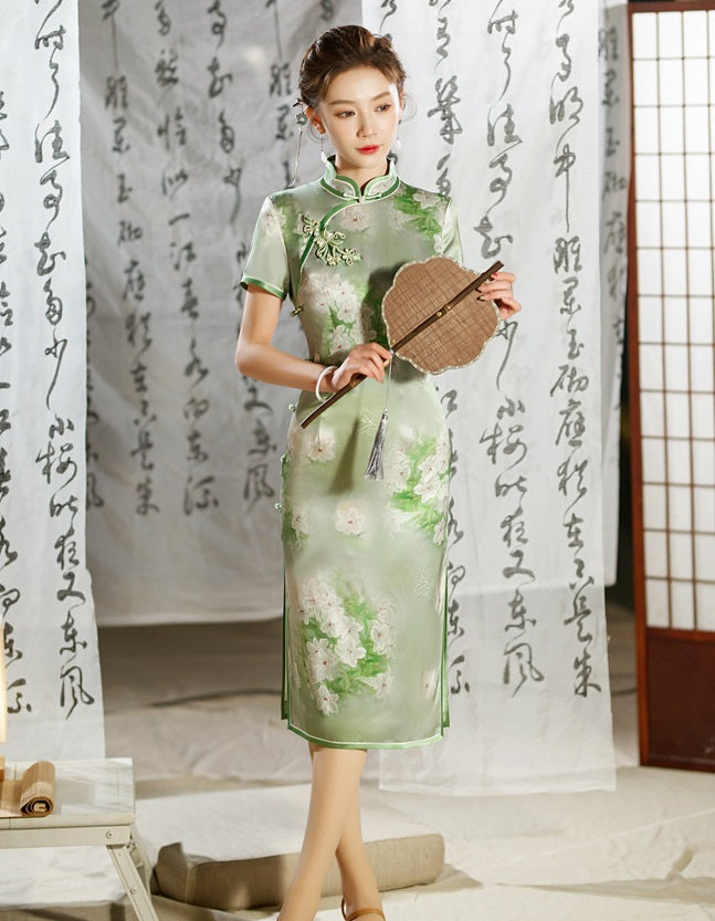 A chinese girl is green silk qipao dress