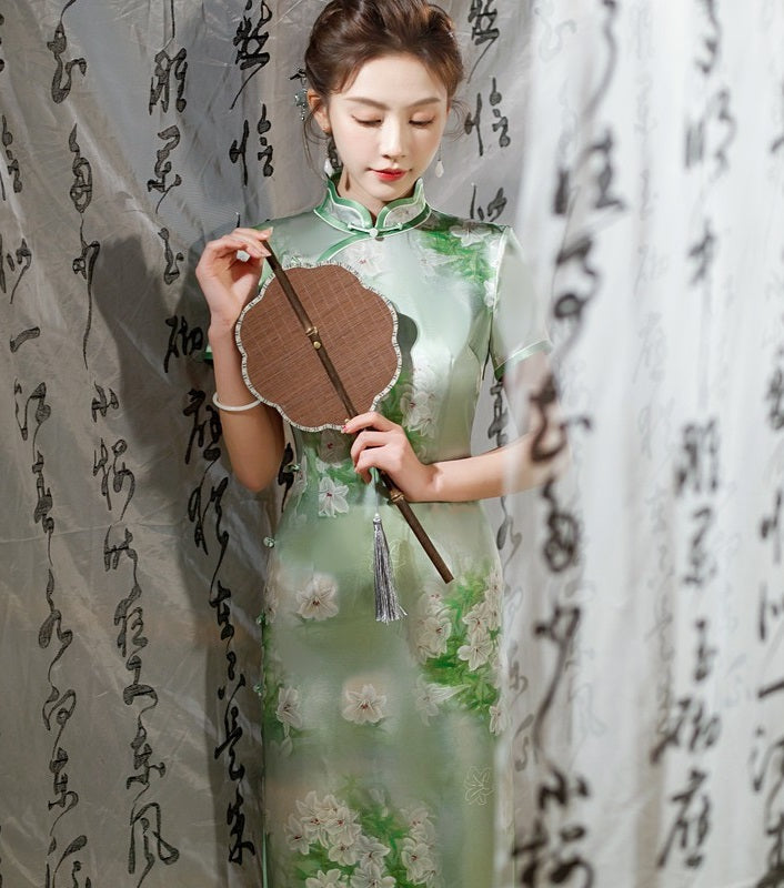 A chinese girl is green silk qipao dress
