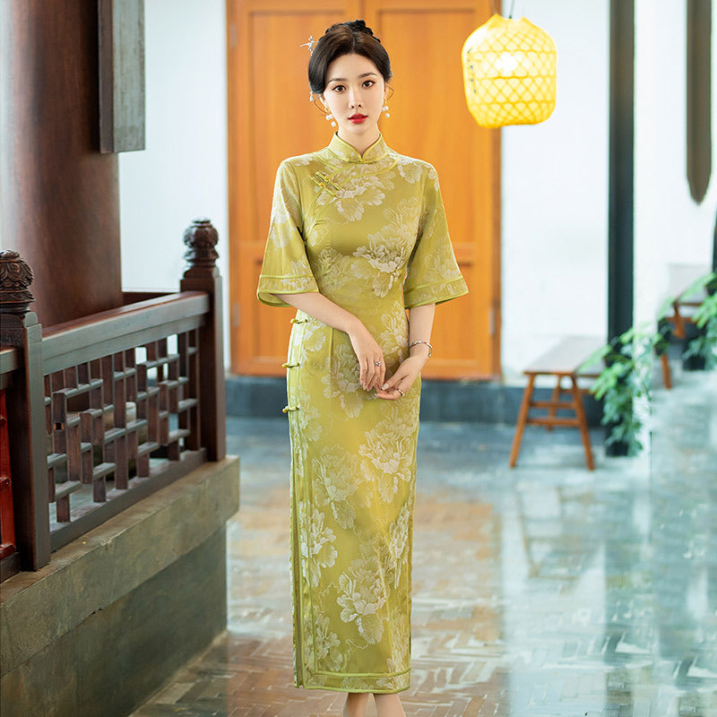 model in half sleevel floral green qipao cheong  dress looking straight
