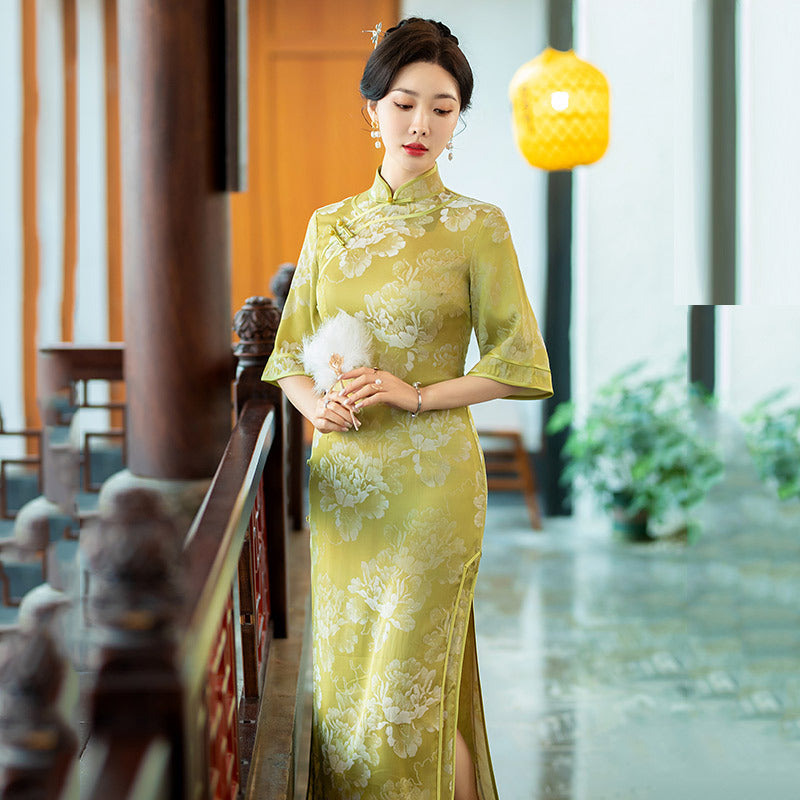 model in half sleevel floral green qipao cheong  dress looking down