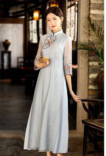 Woman wearing a light blue Modern A Line Loose Cheongsam Qipao Dress with Sheer Sleeve in an indoor setting.