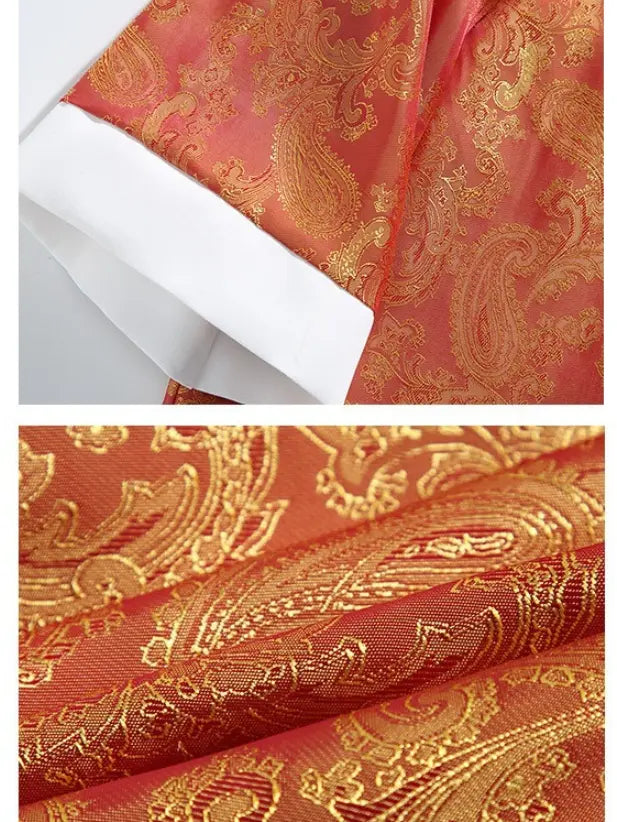 Red fabric with gold paisley pattern and a white paper overlay.