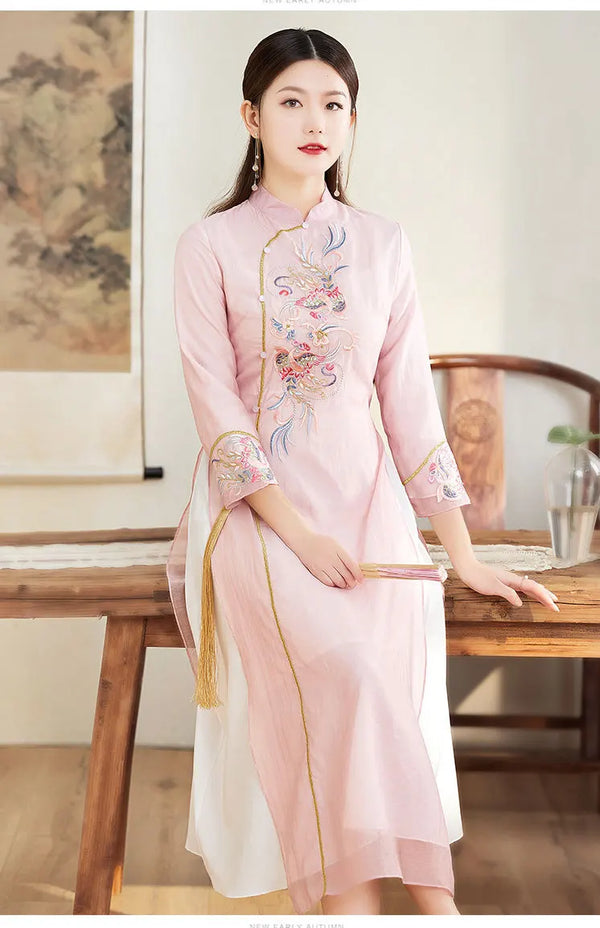 Woman in a  pink Ao Dai Style Qipao Dres – A-Line Long Cheongsam sitting at a wooden table.