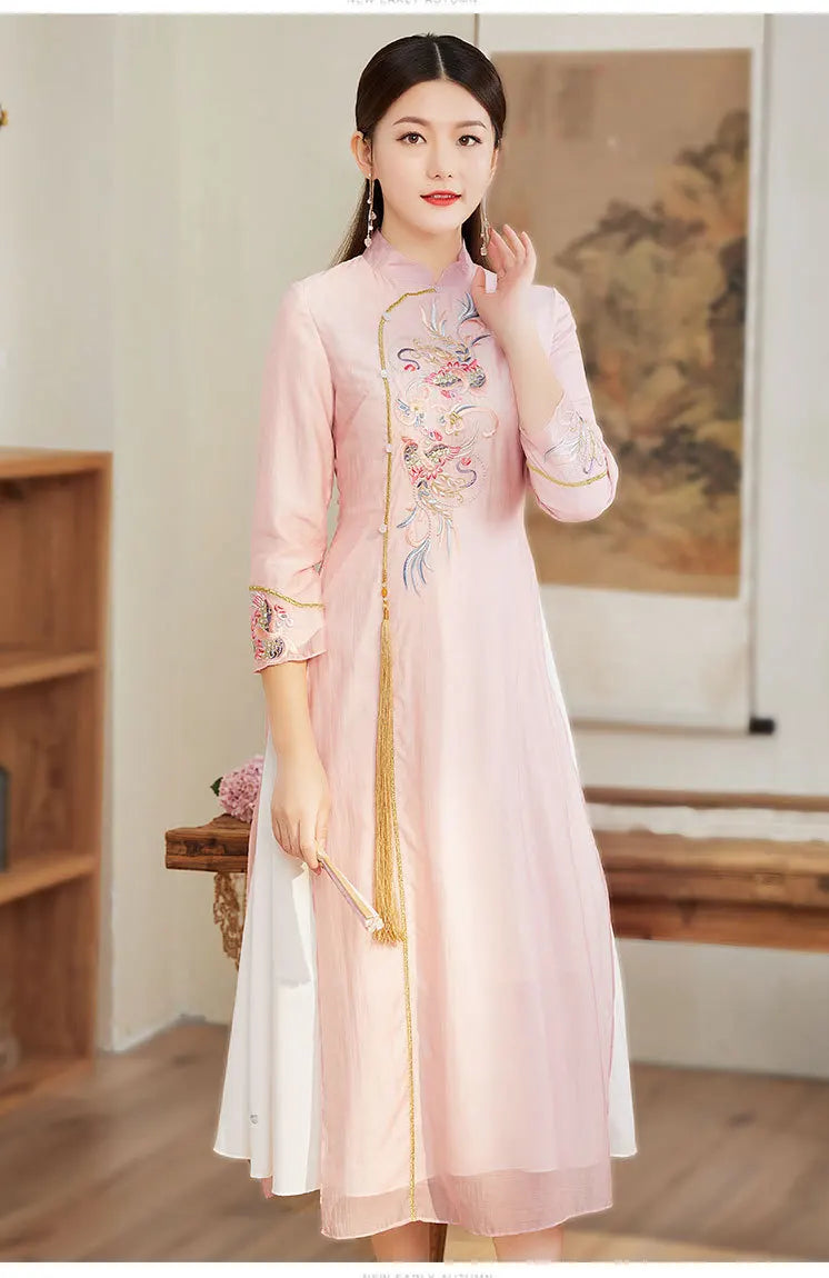 Woman wearing a pink Ao Dai Style Qipao Dres – A-Line Long Cheongsam  with floral embroidery indoors.