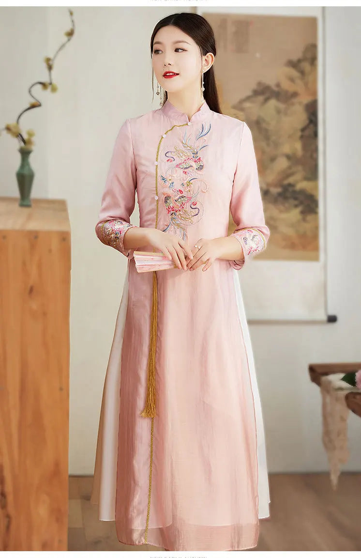 Woman wearing apink Ao Dai Style Qipao Dres – A-Line Long Cheongsam outfit with floral embroidery in a room setting.
