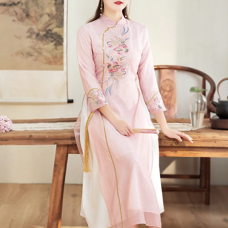 Woman in a pink Ao Dai Style Qipao Dres – A-Line Long Cheongsam sitting at a wooden table in a traditional setting.
