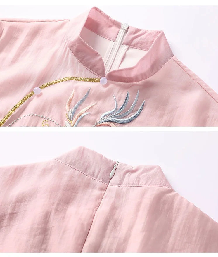 Close-up of a pink garment with intricate embroidery on a white background