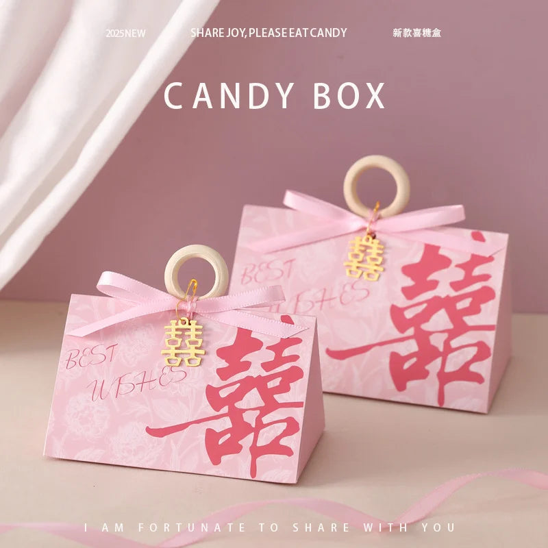 Pink Floral Triangular Shape Double Happiness Favor Boxes candy boxes with Chinese characters and ribbons on a pink background