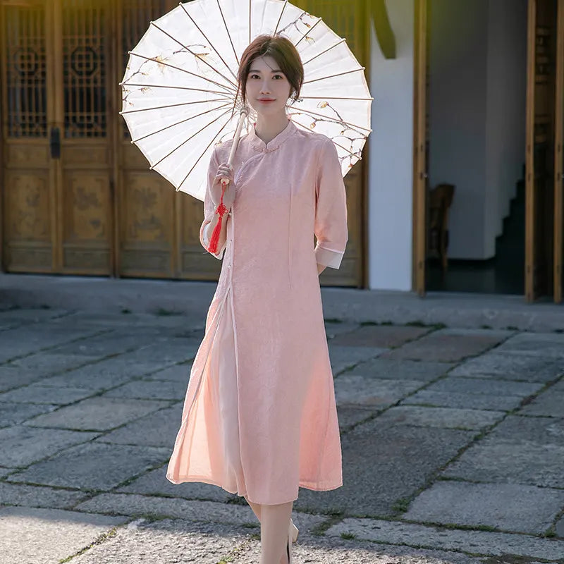 Woman in a pink traditional outfit  Loose A Line Cheongsam Qipao Dress holding a white parasol in an outdoor setting.