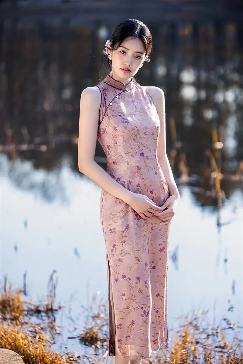 Woman in a floral pink Modern Chinese Mandarin Dress Sleeveless Qipao  standing in a natural setting with blurred background