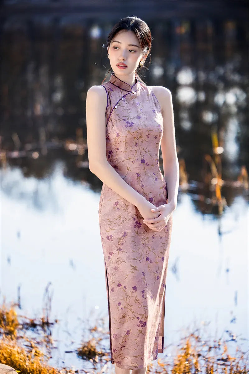 Woman in a floral pink Modern Chinese Mandarin Dress Sleeveless Qipao standing outdoors with a blurred natural background