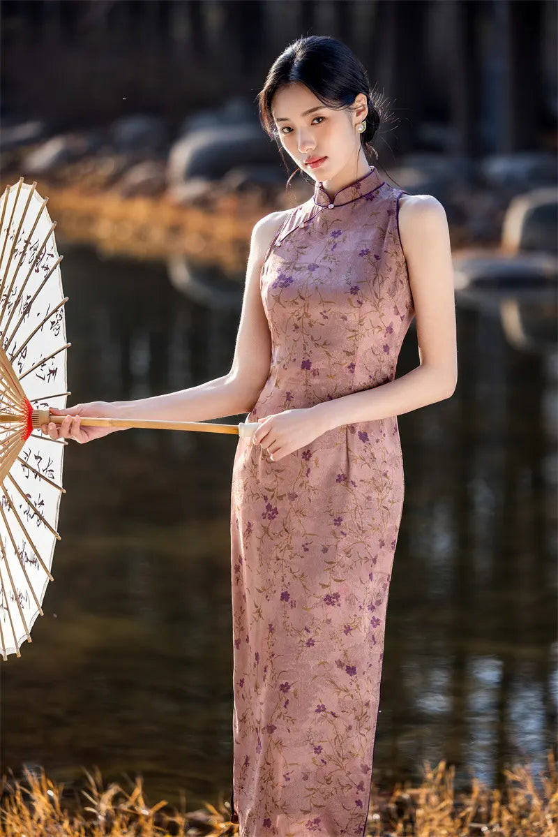 Woman in a floral pink Modern Chinese Mandarin Dress Sleeveless Qipao  holding an umbrella in a natural setting