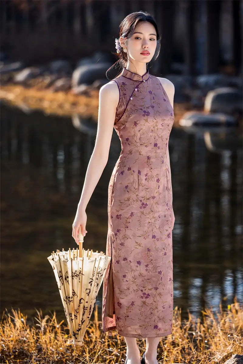 Woman in a floral pink Modern Chinese Mandarin Dress Sleeveless Qipao  holding an umbrella by a body of water