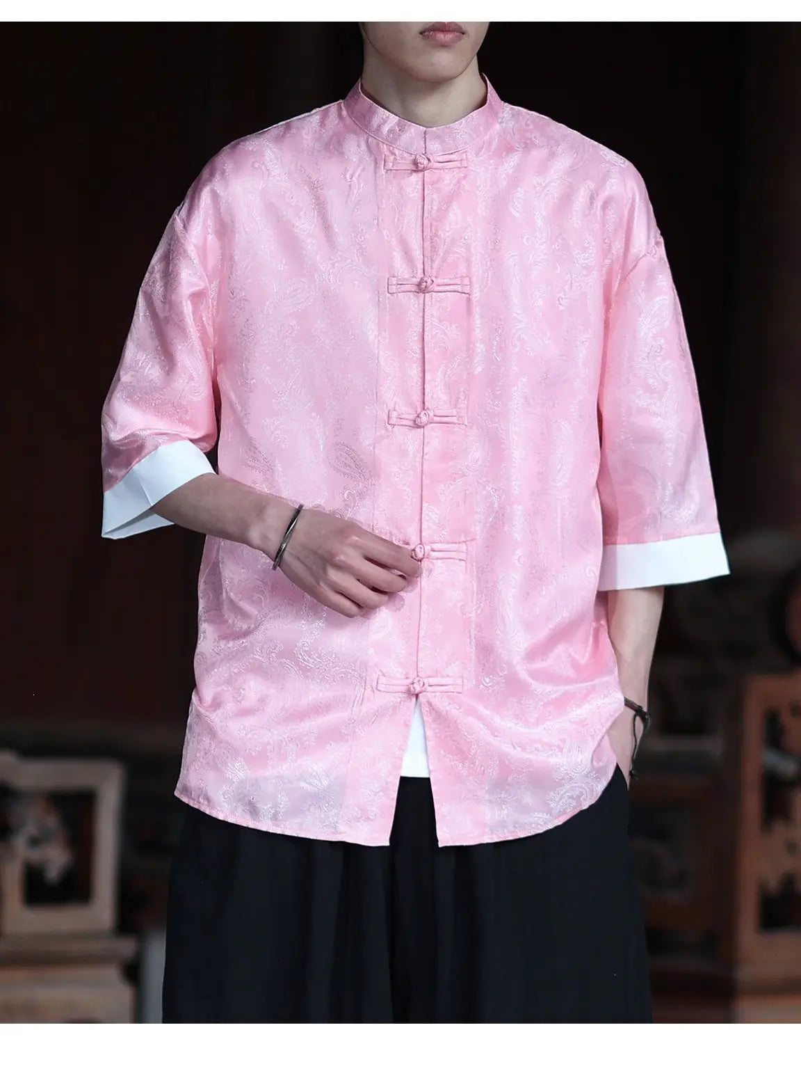 Person wearing a pink traditional Modern New Chinese Style Men's Half Sleeve Jacquard Tang Shirt with a blurred background