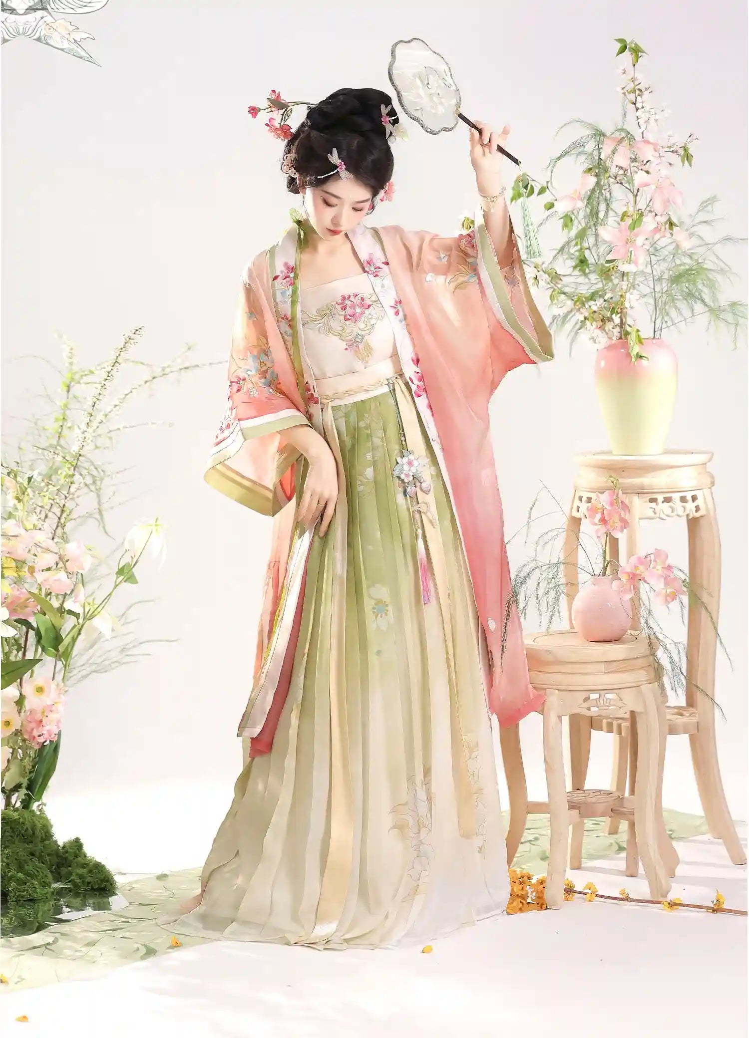 Woman in Traditional Chinese Dress – Elegant pink Song Dynasty Hanfu Set  with floral decorations in a decorative setting