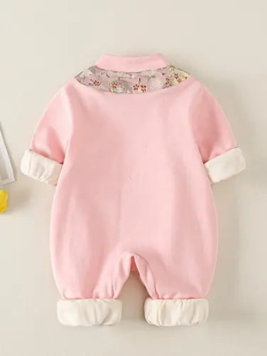A baby's pink Traditional Chinese Embroidered Baby Girl Qipao Romper  jumpsuit shown from the back, featuring a floral patterned collar, cream-colored cuffs, and matching cream foot cuffs, displayed against a light beige background.
