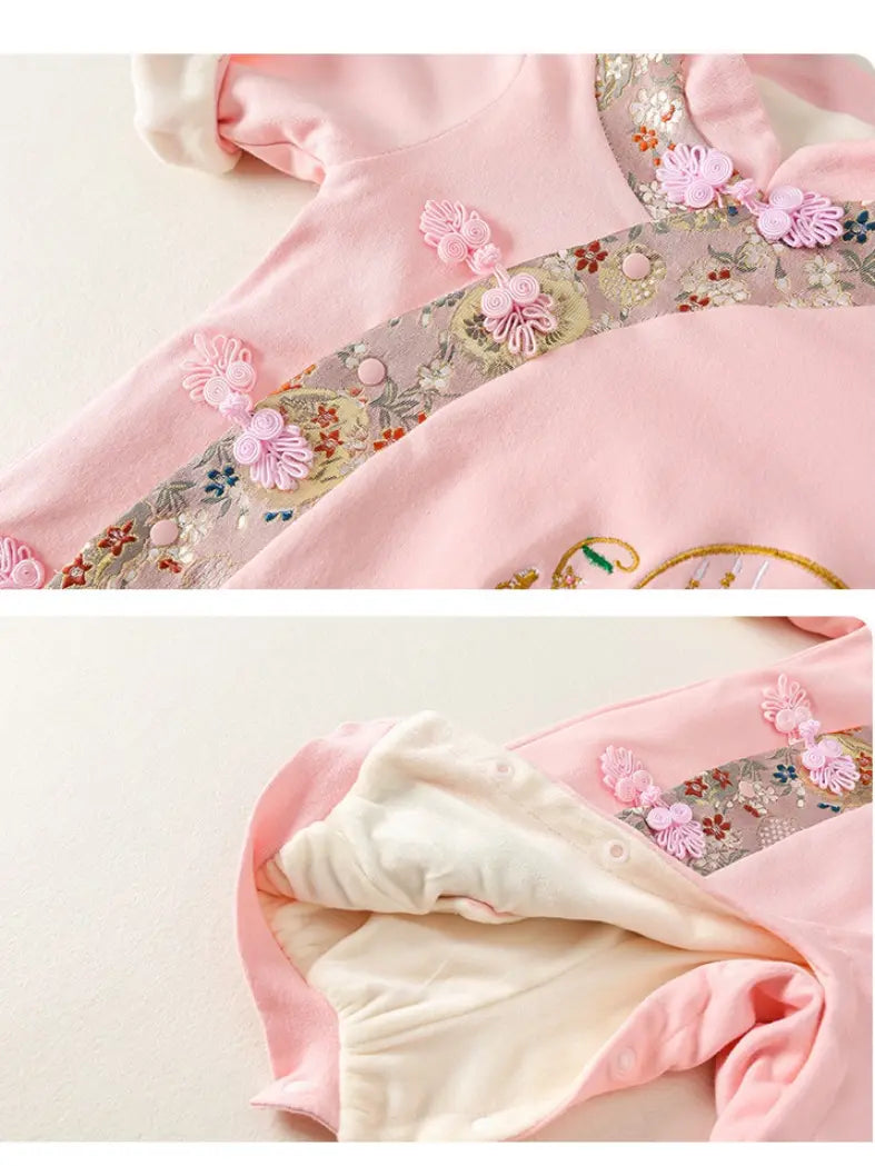 A close-up of a Traditional Chinese Embroidered Baby Girl Qipao Romper  outfit or garment in soft pink, showing floral embroidery, decorative pink applique, and a cream-colored lining. The top panel shows the exterior detail, while the bottom panel shows the interior lining folded back.