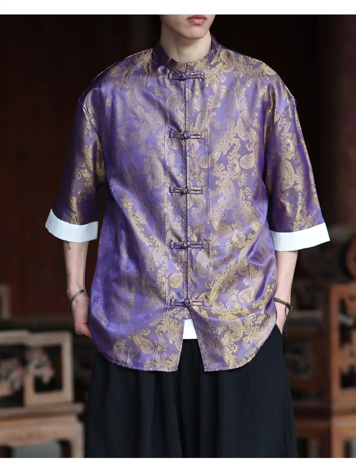 Person wearing a purple and gold traditional Modern New Chinese Style Men's Half Sleeve Jacquard Tang Shirt outfit with a blurred background