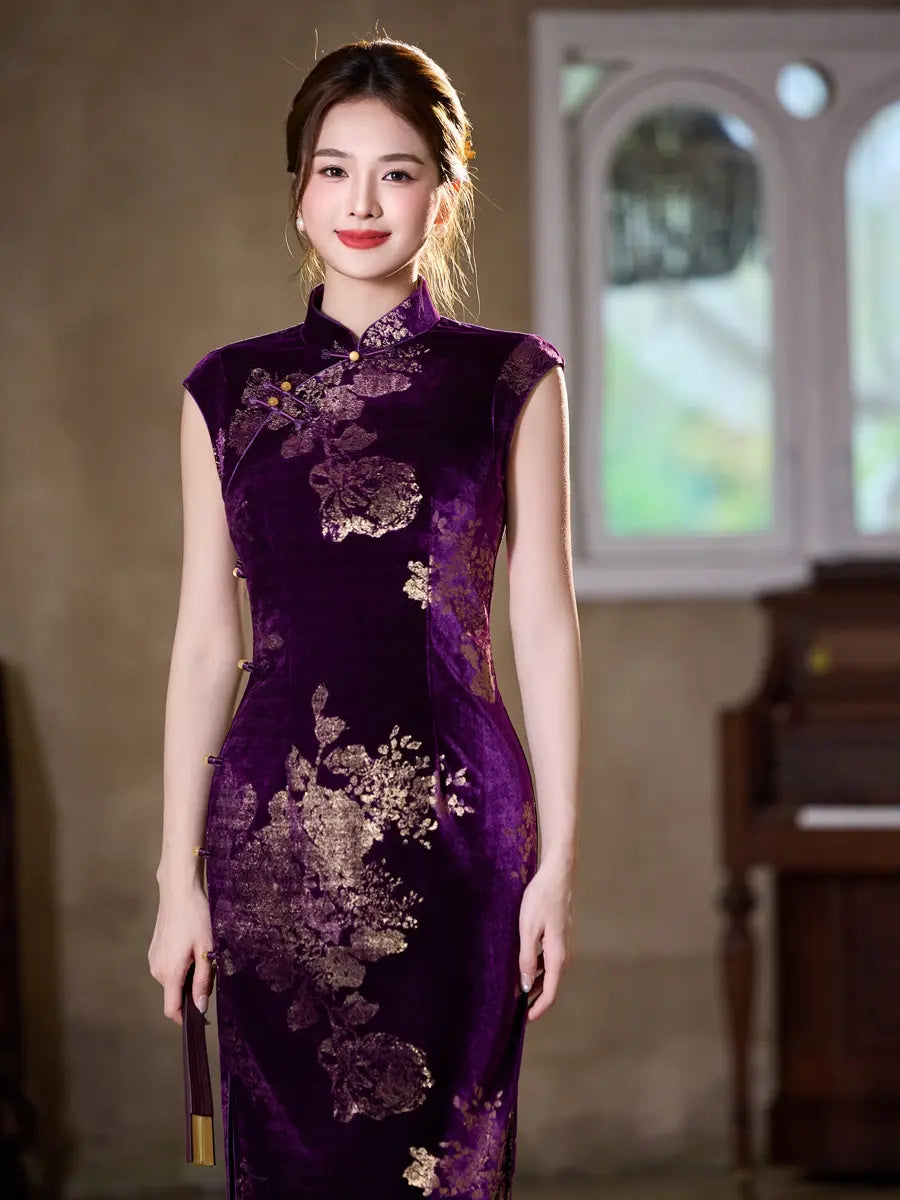 A woman wearing a sleeveless deep purple cheongsam dress with gold floral embroidery, standing in an indoor setting with a blurred piano and window in the background.