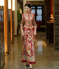 Bride wearing a traditional red Qun Kwa embroidered with golden phoenix and dragon motifs.